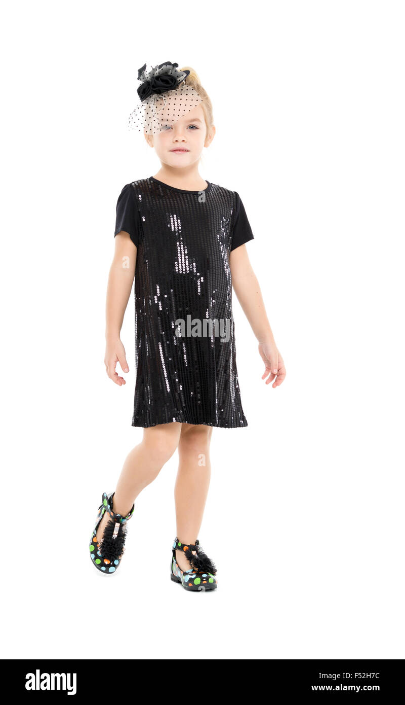 Little Girl in a Black Dress Posing, on white background Stock Photo