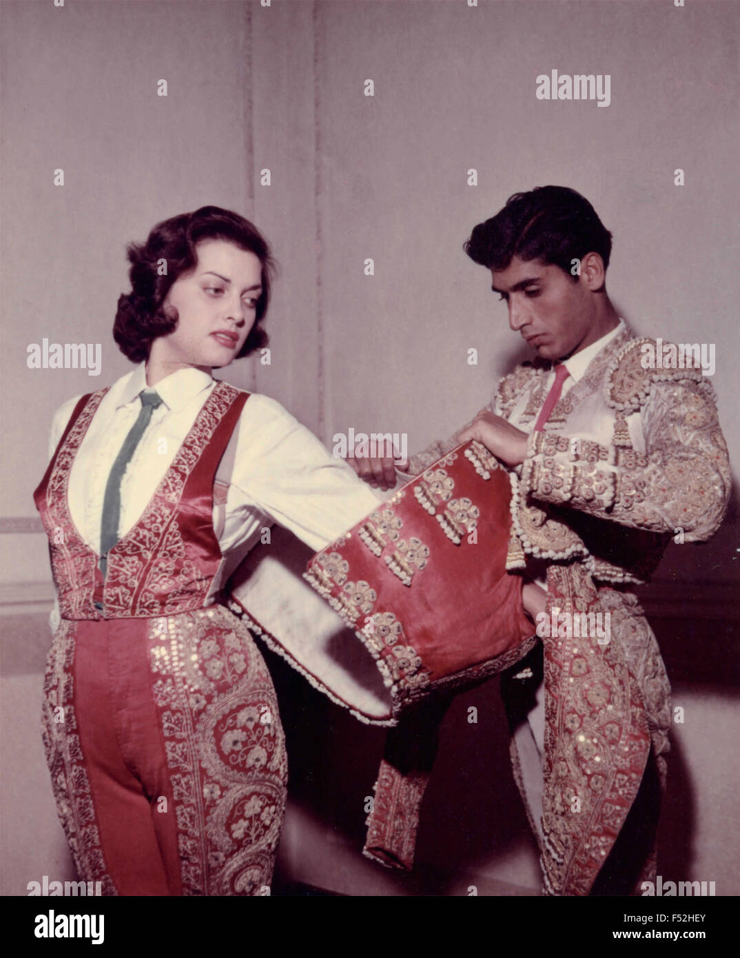 The Italian actress Lucia Banti while dressing bullfighter for filming of ' Fiesta Brava ' Stock Photo