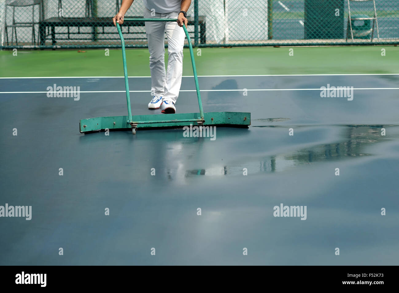 cleaning crew drying tennis court after rain Stock Photo Alamy