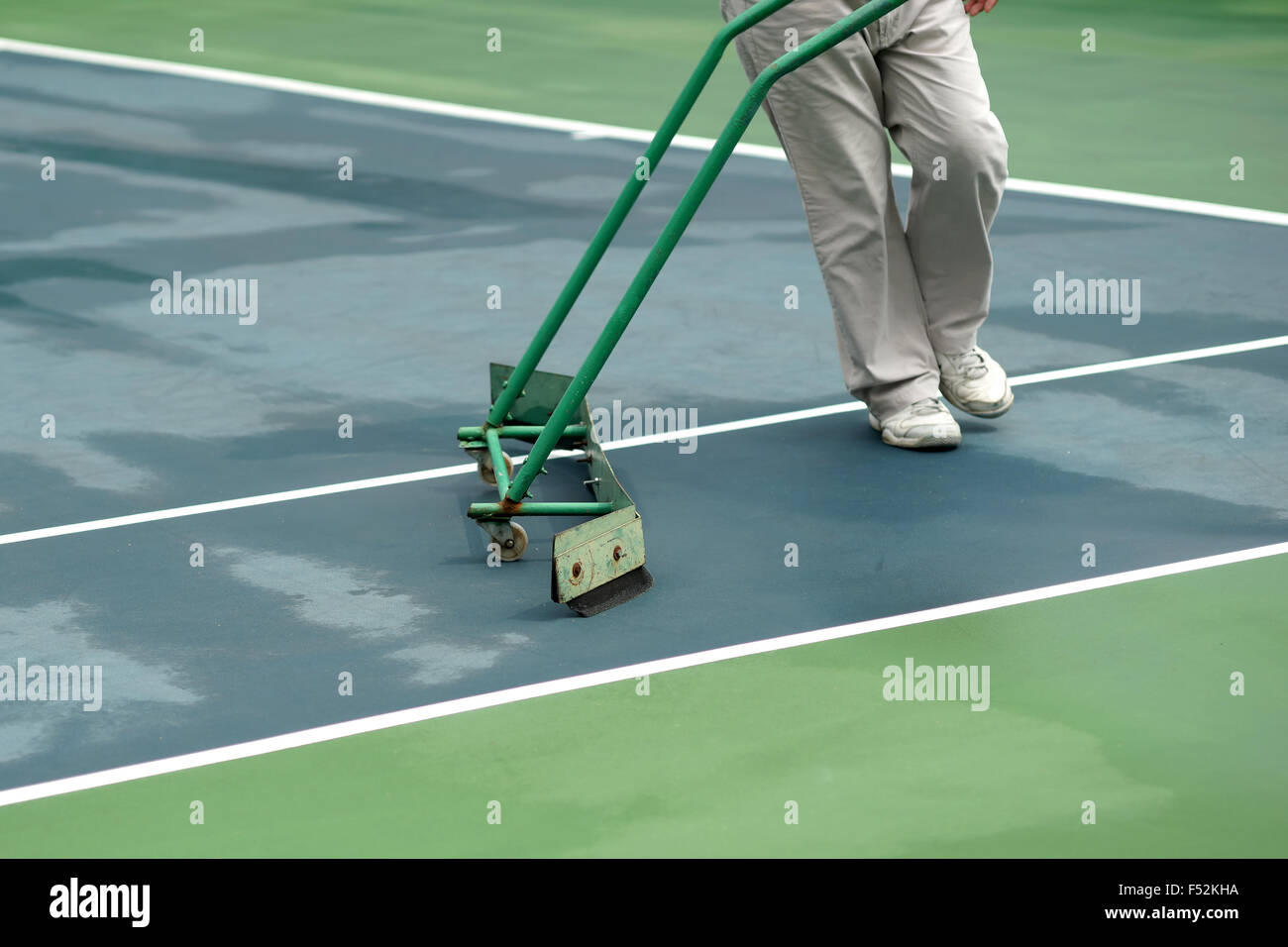 cleaning crew drying tennis court after rain Stock Photo Alamy