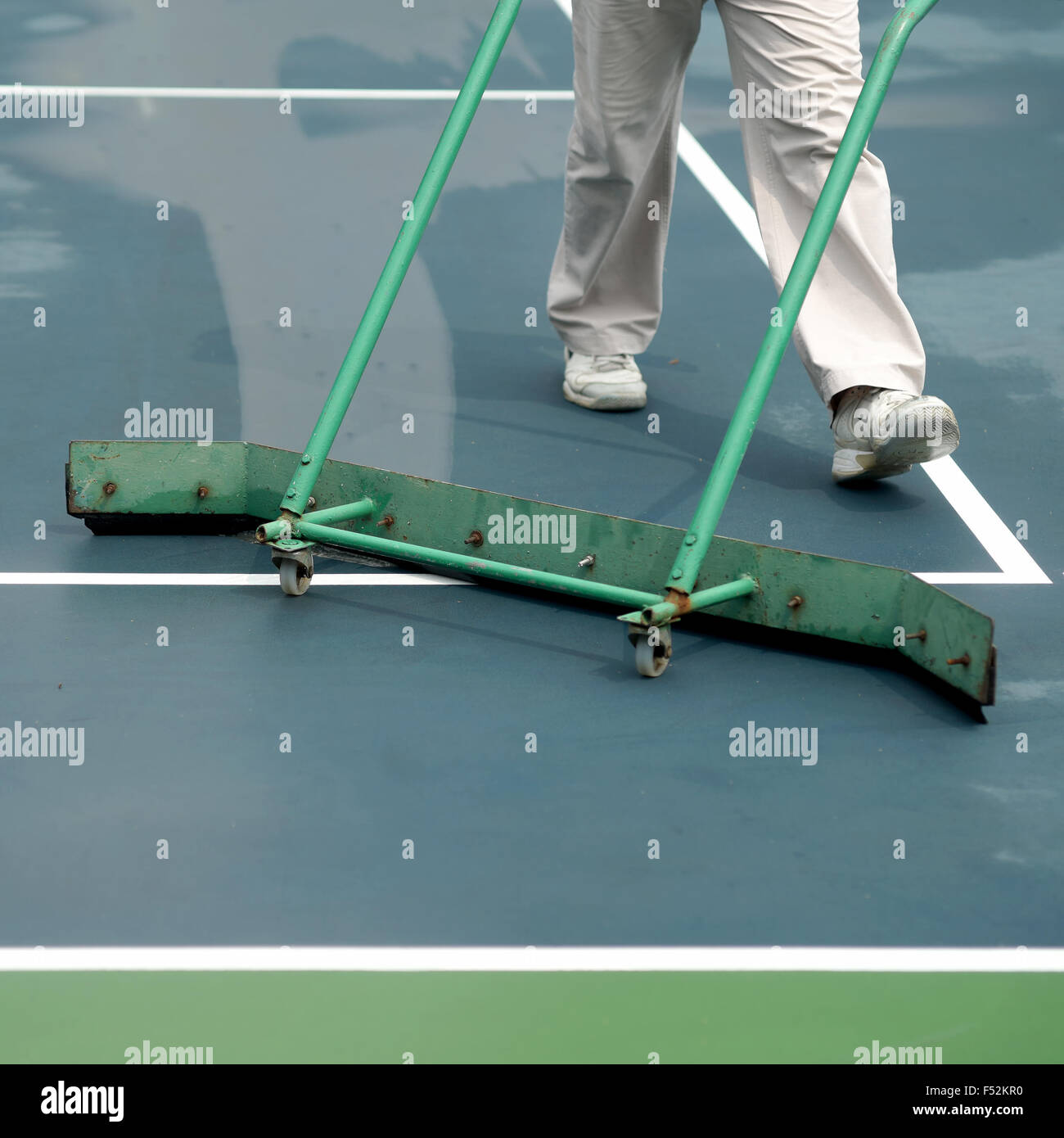 cleaning crew drying tennis court after rain Stock Photo Alamy