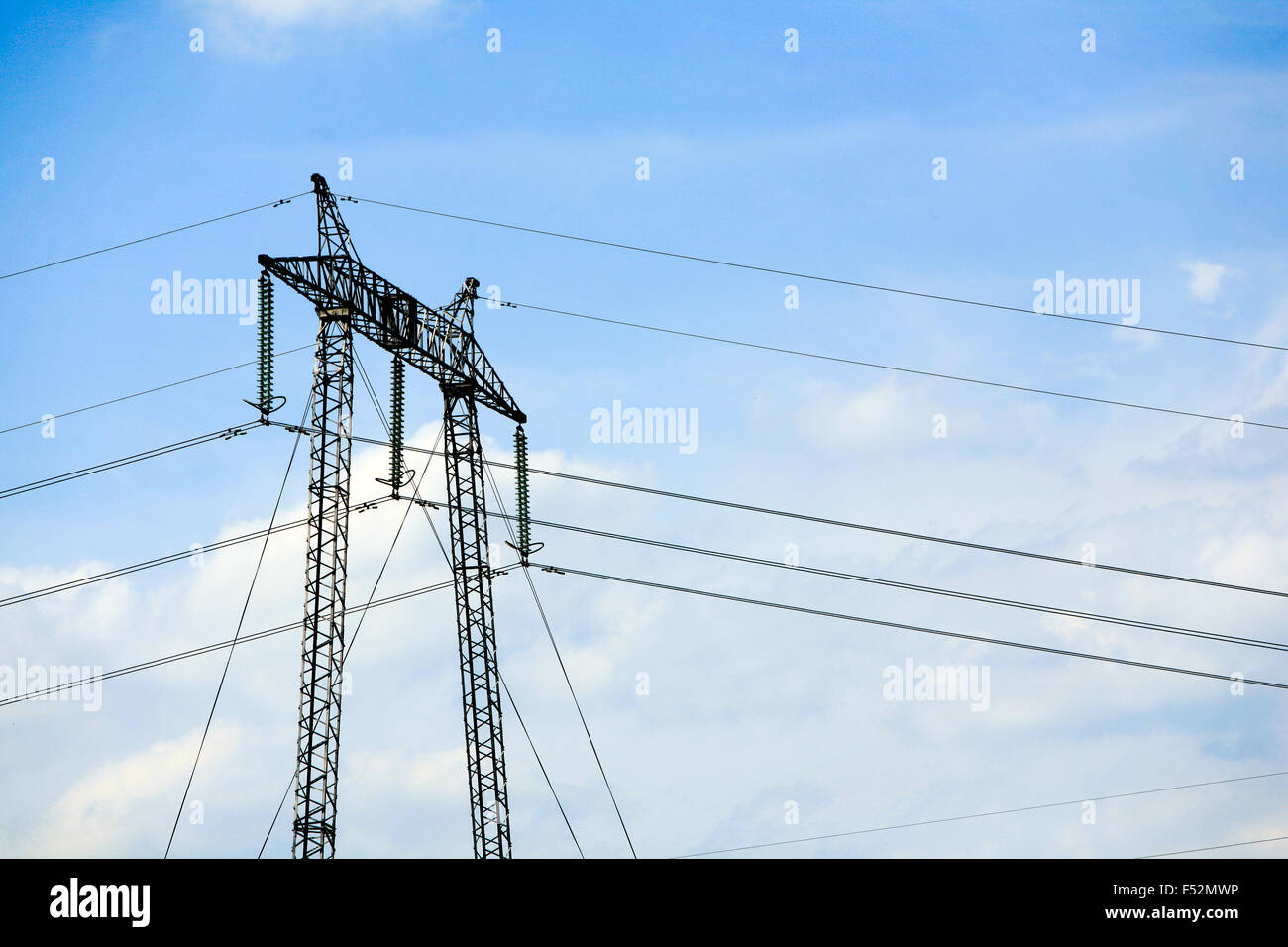 High Voltage Electrical Pylon Against Clear Blue Sky Stock Photo