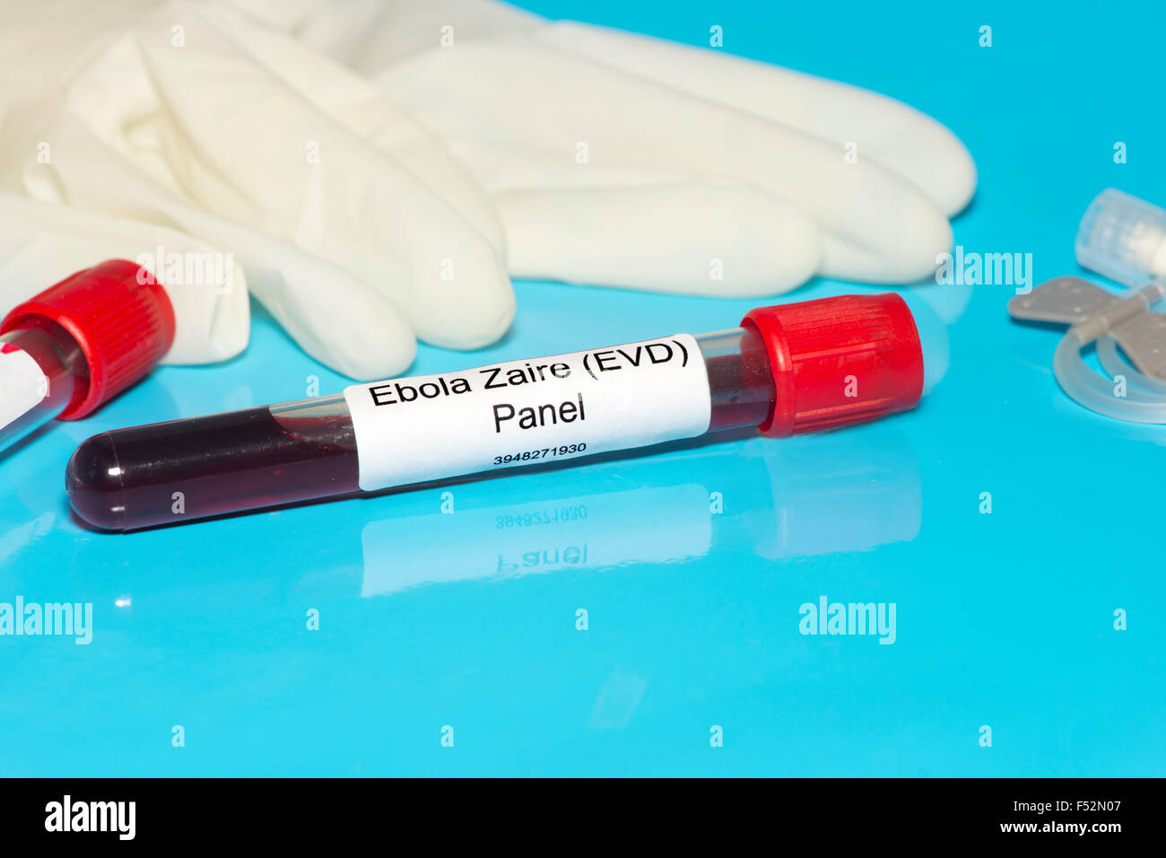 Ebola Zaire blood test panel lab sample with gloves and IV blood draw needle.  Label is fictitious. Stock Photo