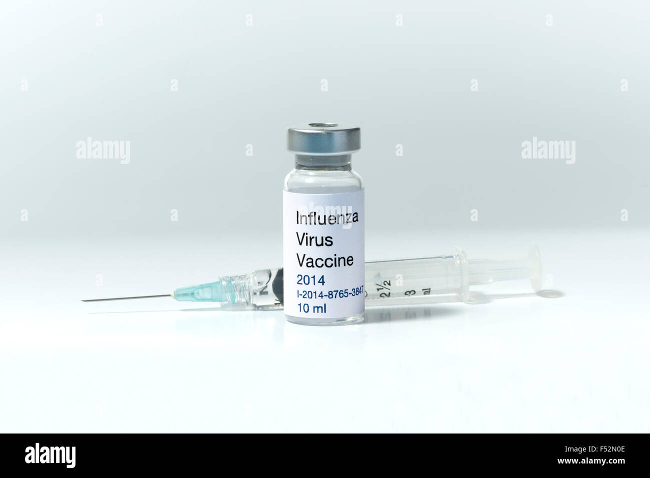 New 2014  Influenza vaccine vial with syringe.  Label is fictitious. Stock Photo