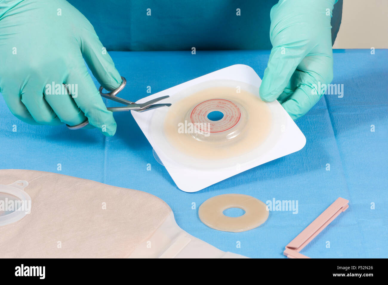 Nurse prepares ostomy supplies for use with patient. Stock Photo