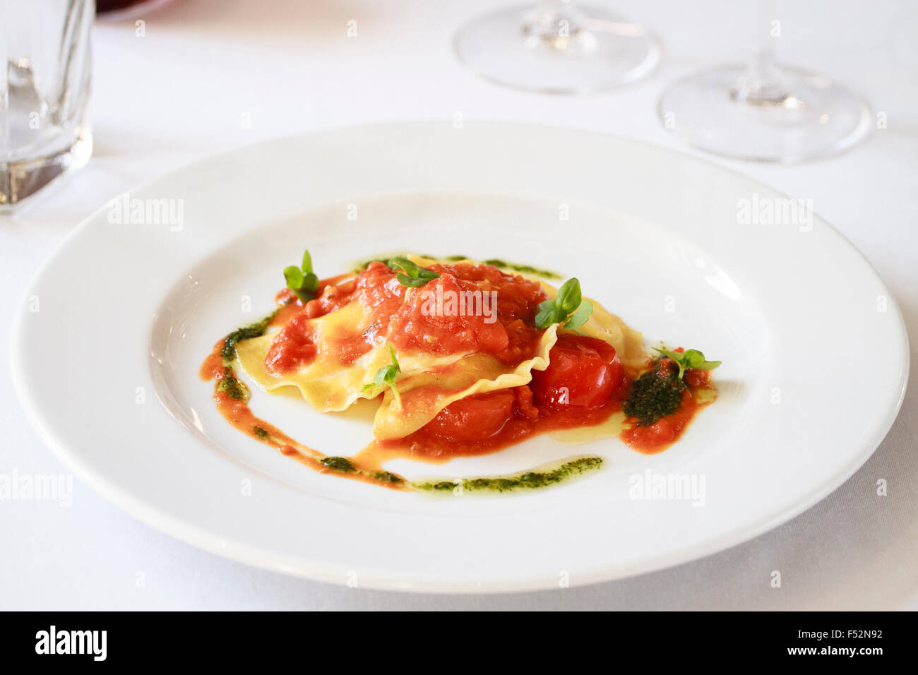 Goats cheese Ravioli with Cherry tomato sauce & pesto Stock Photo Alamy