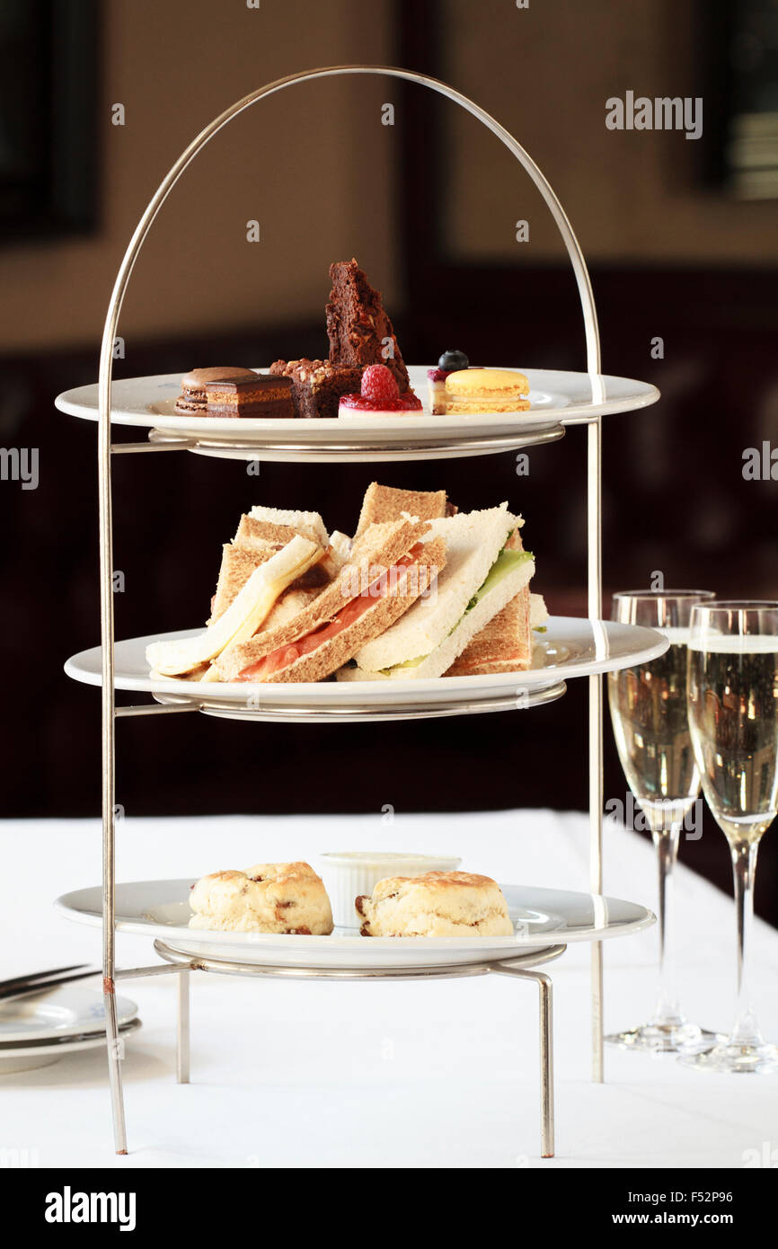 Afternoon tea with glasses of Champagne served at Beaufort House, London Stock Photo