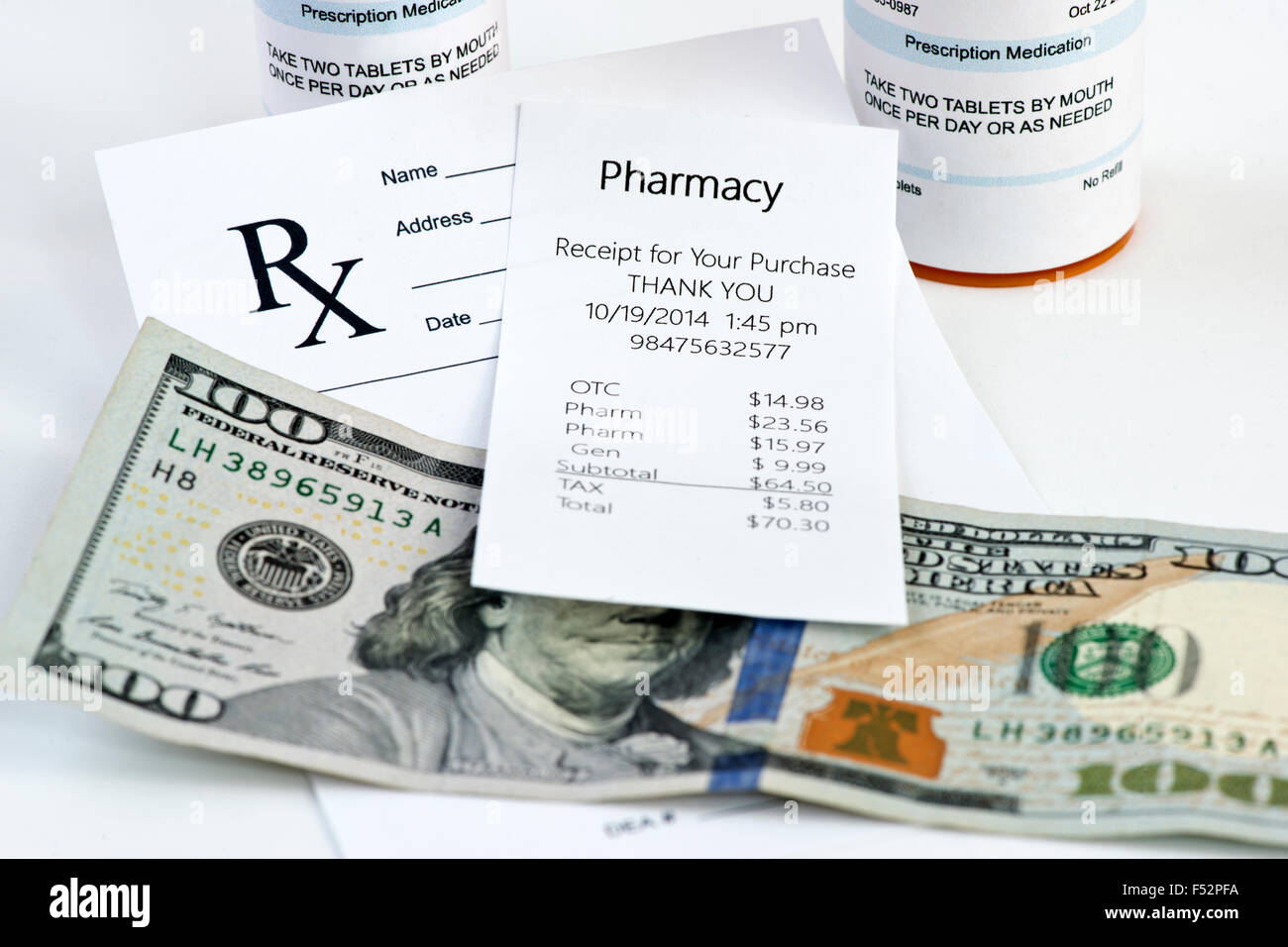 Pharmacy receipt with prescription bottle and prescription on neutral background. Stock Photo