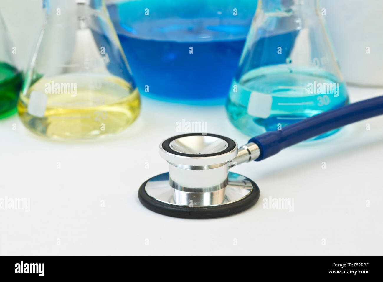 Stethoscope with medical research equipment in background. Stock Photo