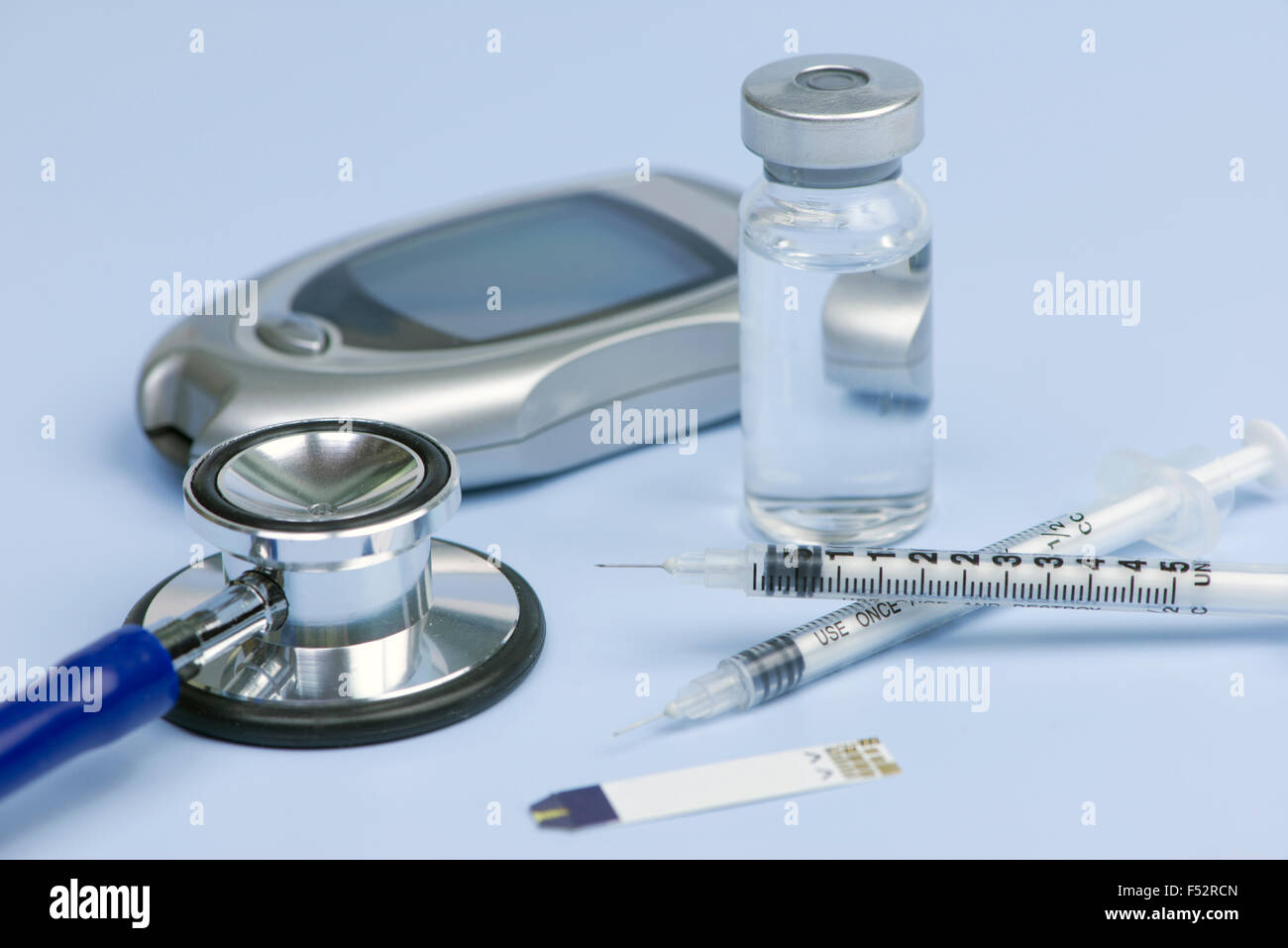 Insulin syringes, test strip, stethoscope, insulin vial, and