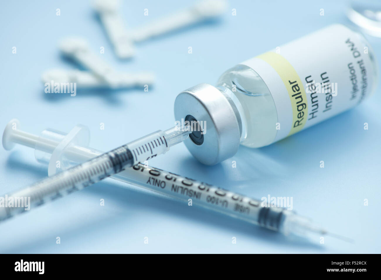 Insulin syringe draws insulin from regular insulin vial with lancets
