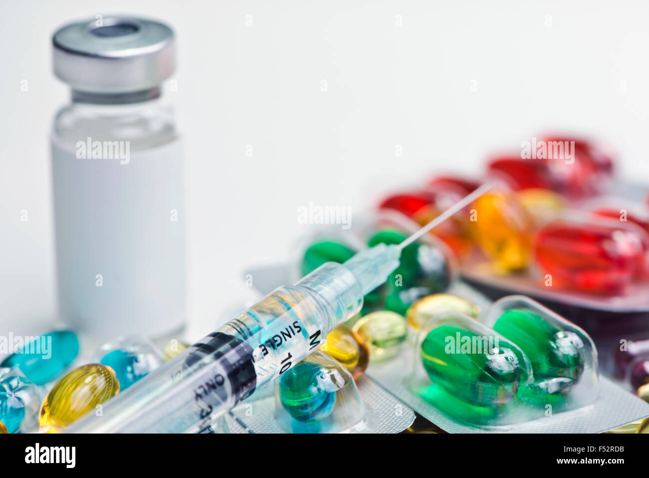 Vial with blank label, syringe and blister packs of medication Stock