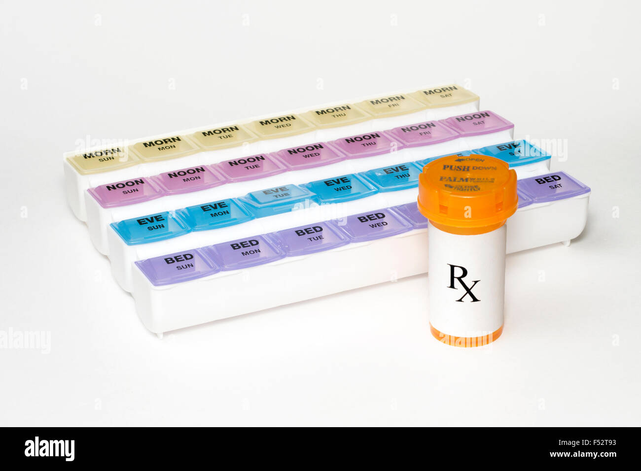 Daily medication dispenser with prescription bottle Stock Photo Alamy