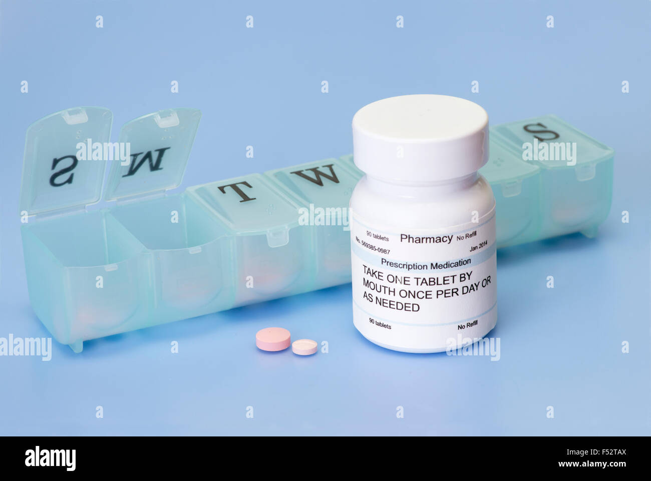 Prescription bottle and pills with daily medication dispenser Stock