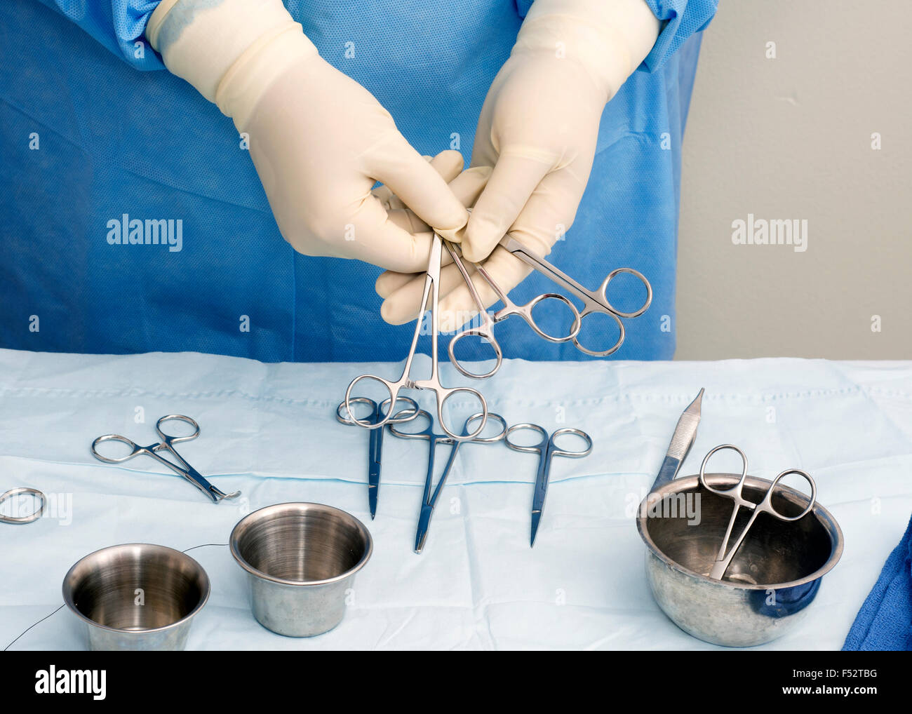 Surgical technician offers a selection of intruments for use during