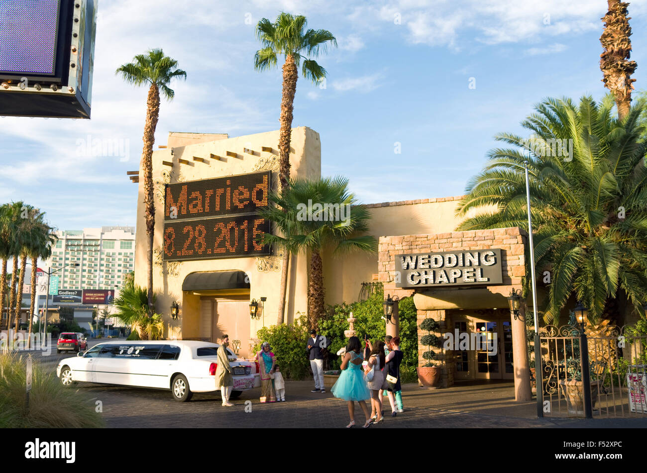 Las Vegas, USA. 27th Aug, 2015. Newlyweds Kirti and David Cartwright from Leicester, UK, stand with their families after their Elvis wedding outside the Viva Las Vegas wedding chapel in Las Vegas, USA, 27 August 2015. Every year, more than 80,000 marriages take place in Vegas, according to city authorities - an average of 200 per day. PHOTO: MARCUS TEPLY/DPA/Alamy Live News Stock Photo