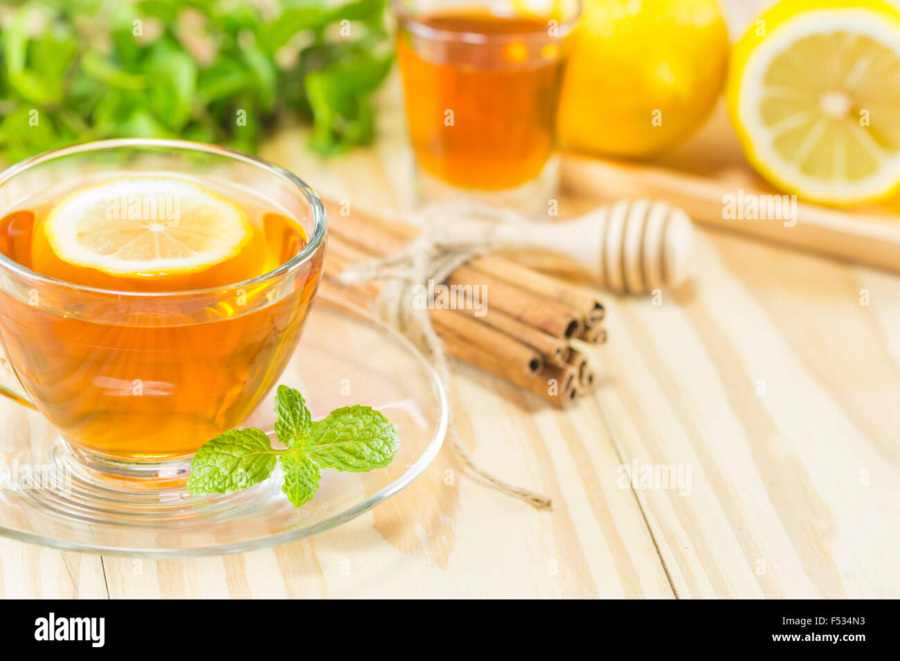 tea with mint honey cinnamon and lemon on wood background,warm toning, selective focus Stock Photo