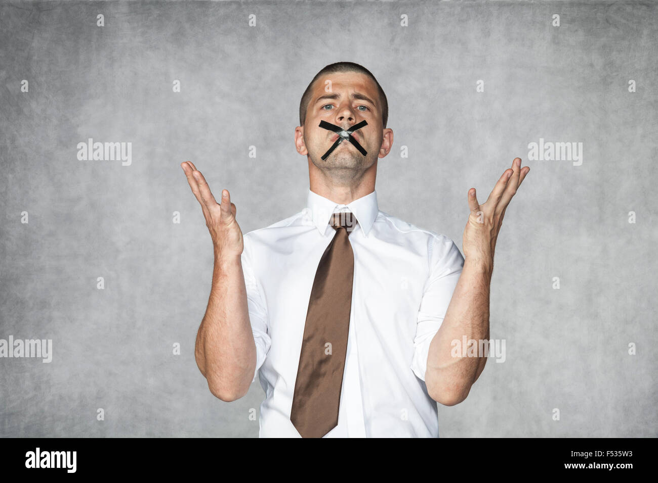 angry businessman cant give his speech, closed mouth Stock Photo - Alamy