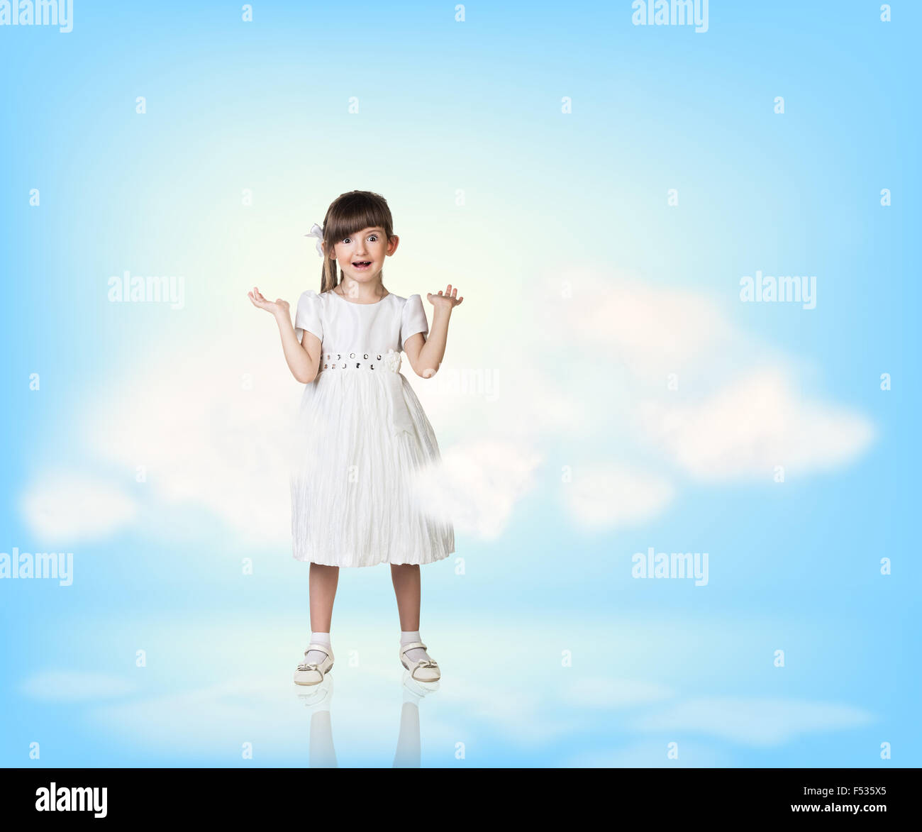 Cute little girl in blue sky with clouds Stock Photo - Alamy