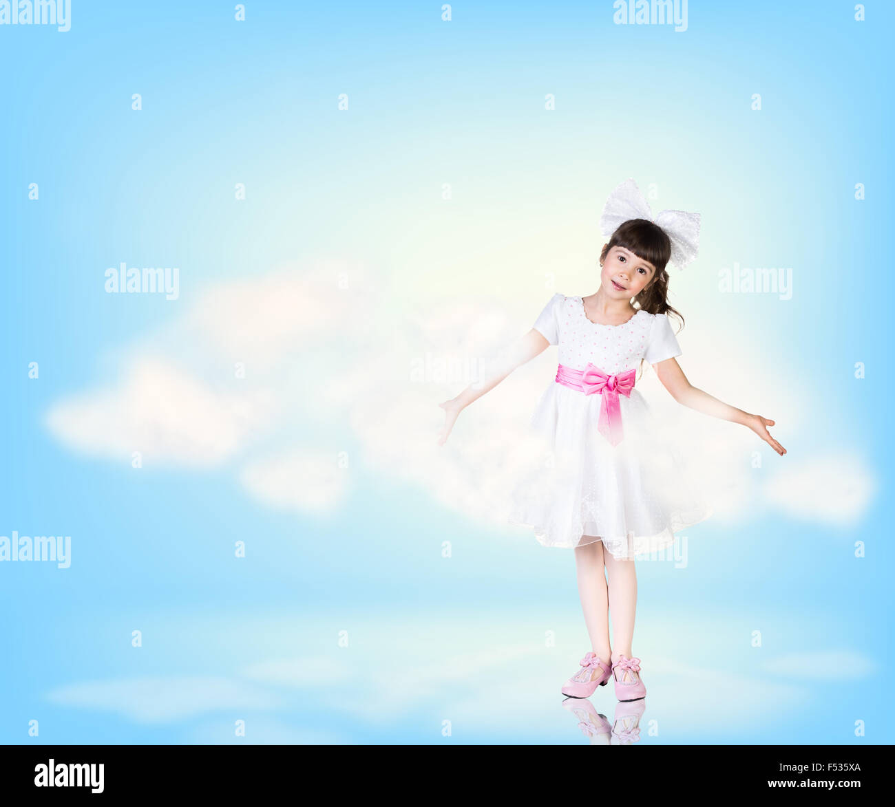 Cute little girl in blue sky with clouds Stock Photo - Alamy