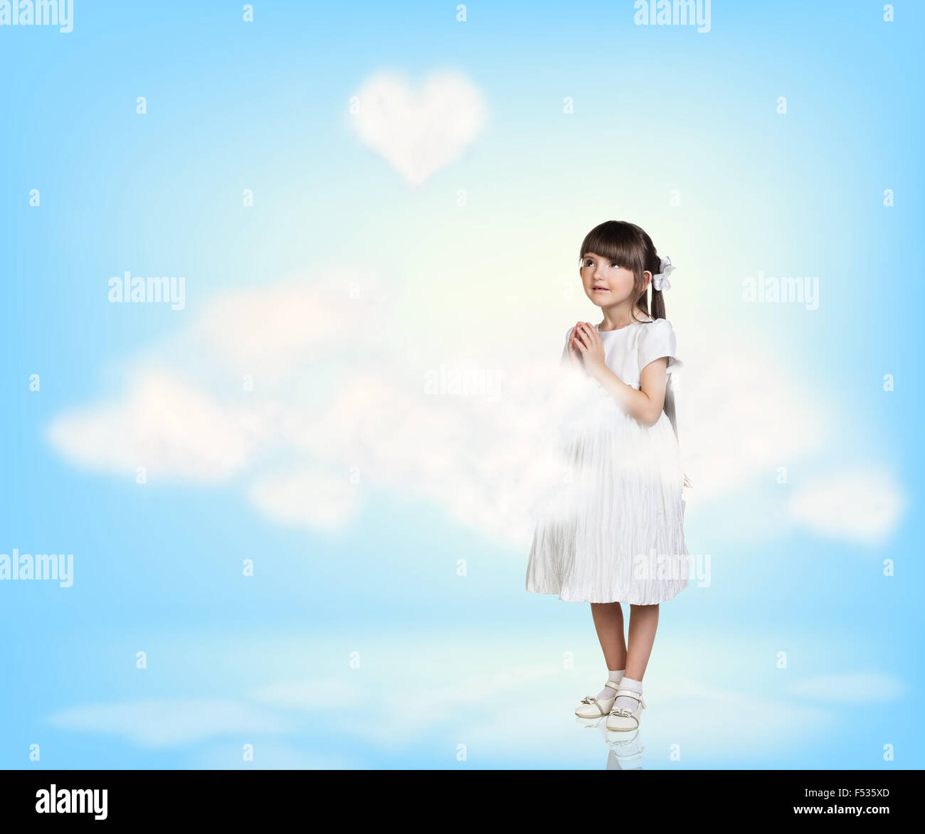 Cute little girl in blue sky with clouds Stock Photo - Alamy