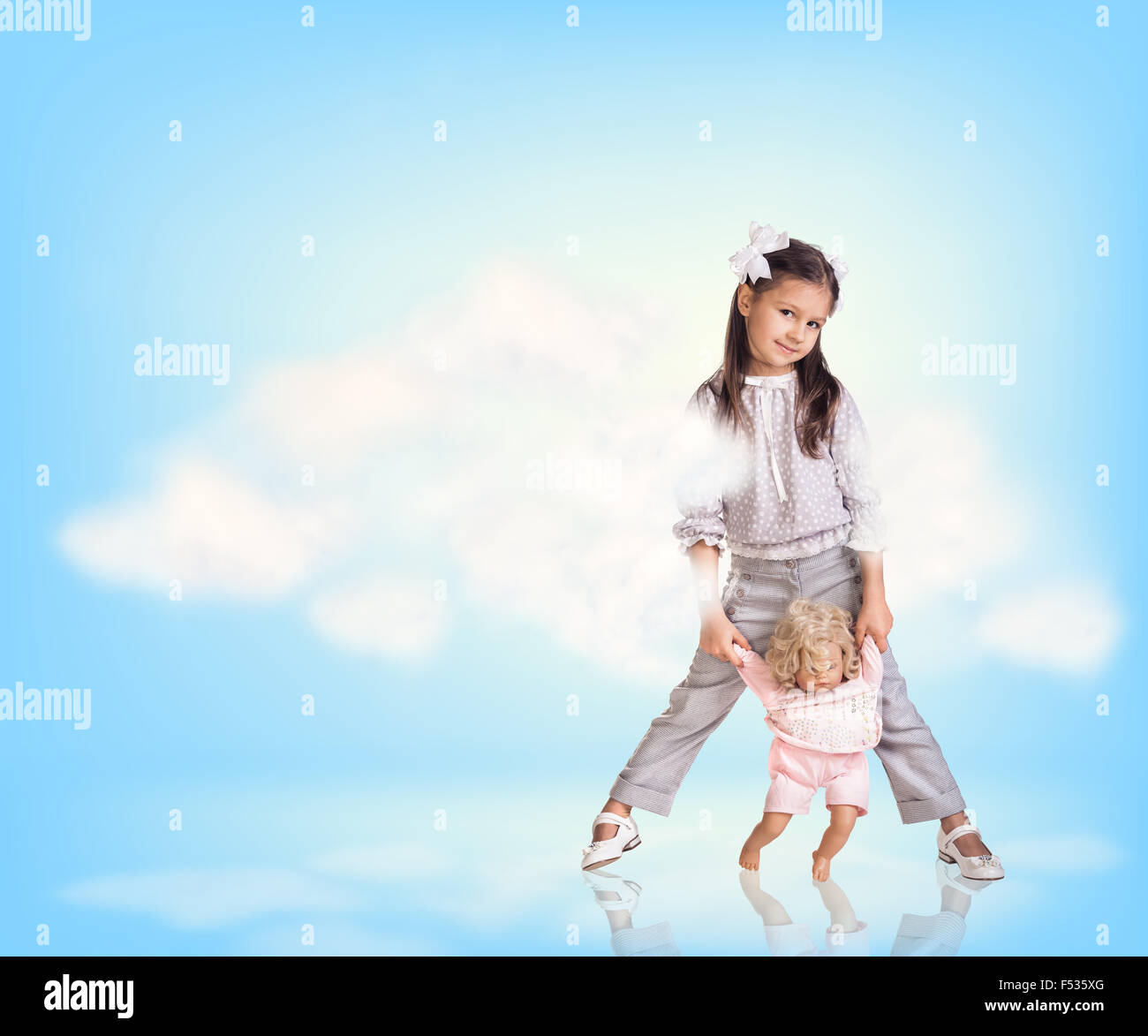 Cute little girl in blue sky with clouds Stock Photo - Alamy