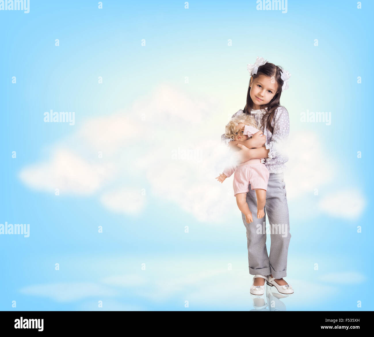 Cute little girl in blue sky with clouds Stock Photo - Alamy