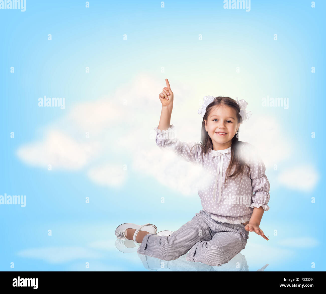 Cute little girl in blue sky with clouds Stock Photo - Alamy