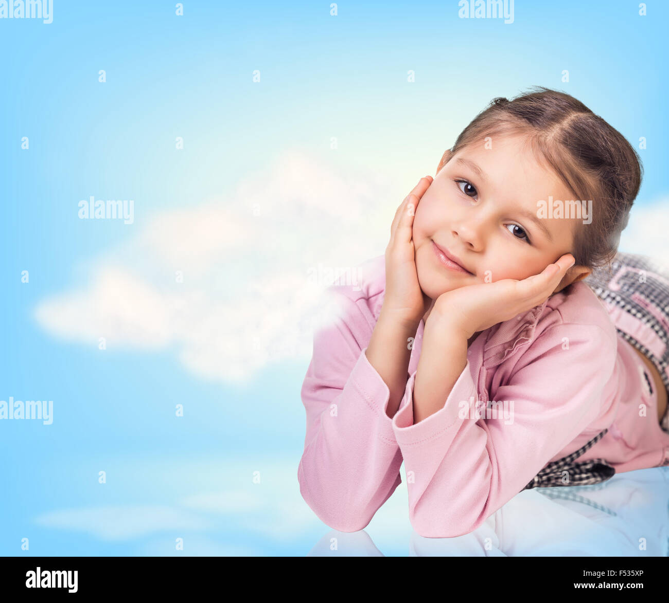 Cute little girl in blue sky with clouds Stock Photo - Alamy