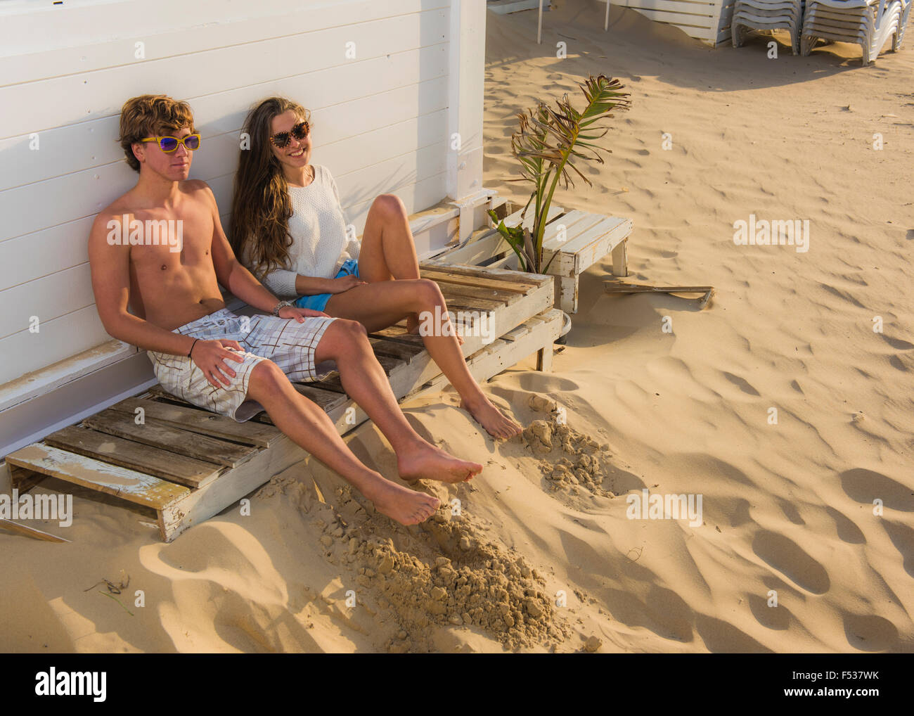 Young couple chilling out at the beach. Stock Photo