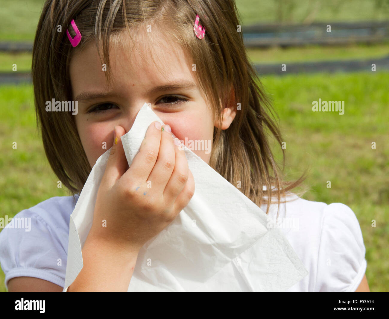 Little girl with handkerchief outdoor pollen allergy Stock Photo