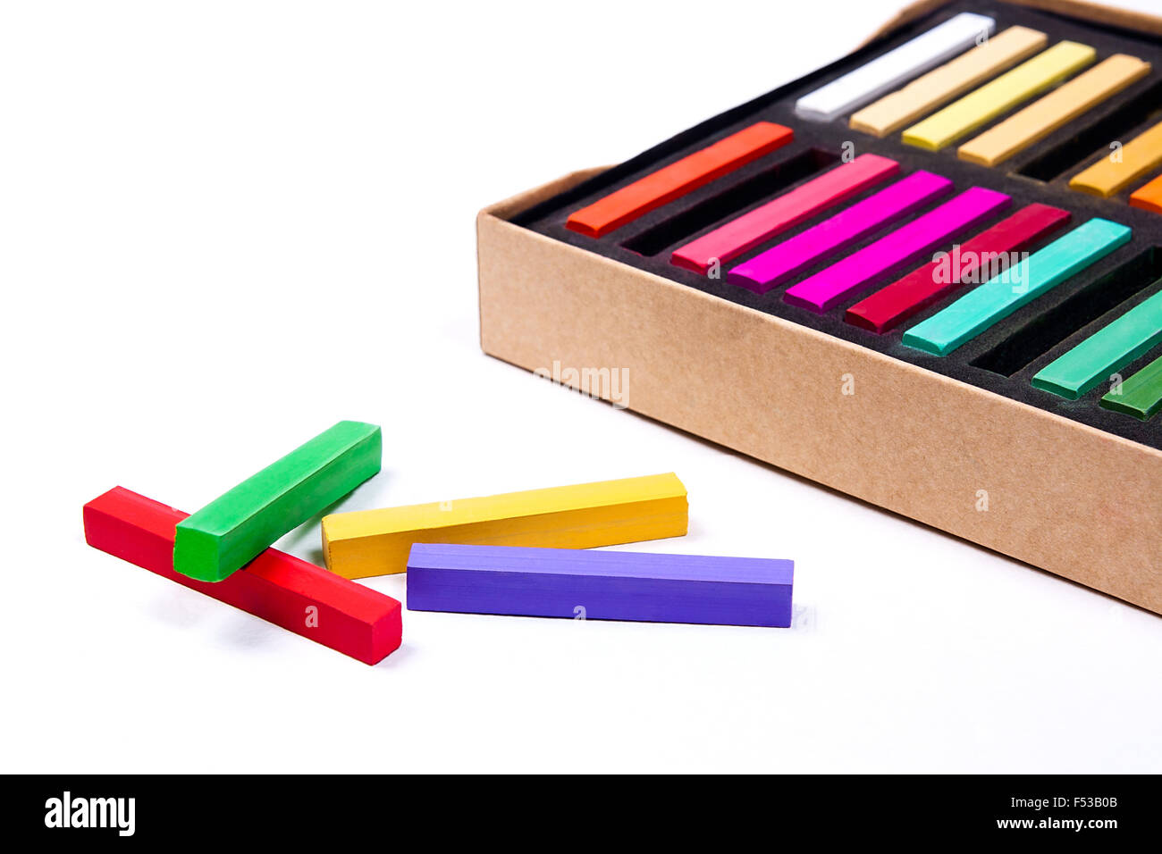 Close up view of the colorful chalk pastels and box on the white background. Stock Photo