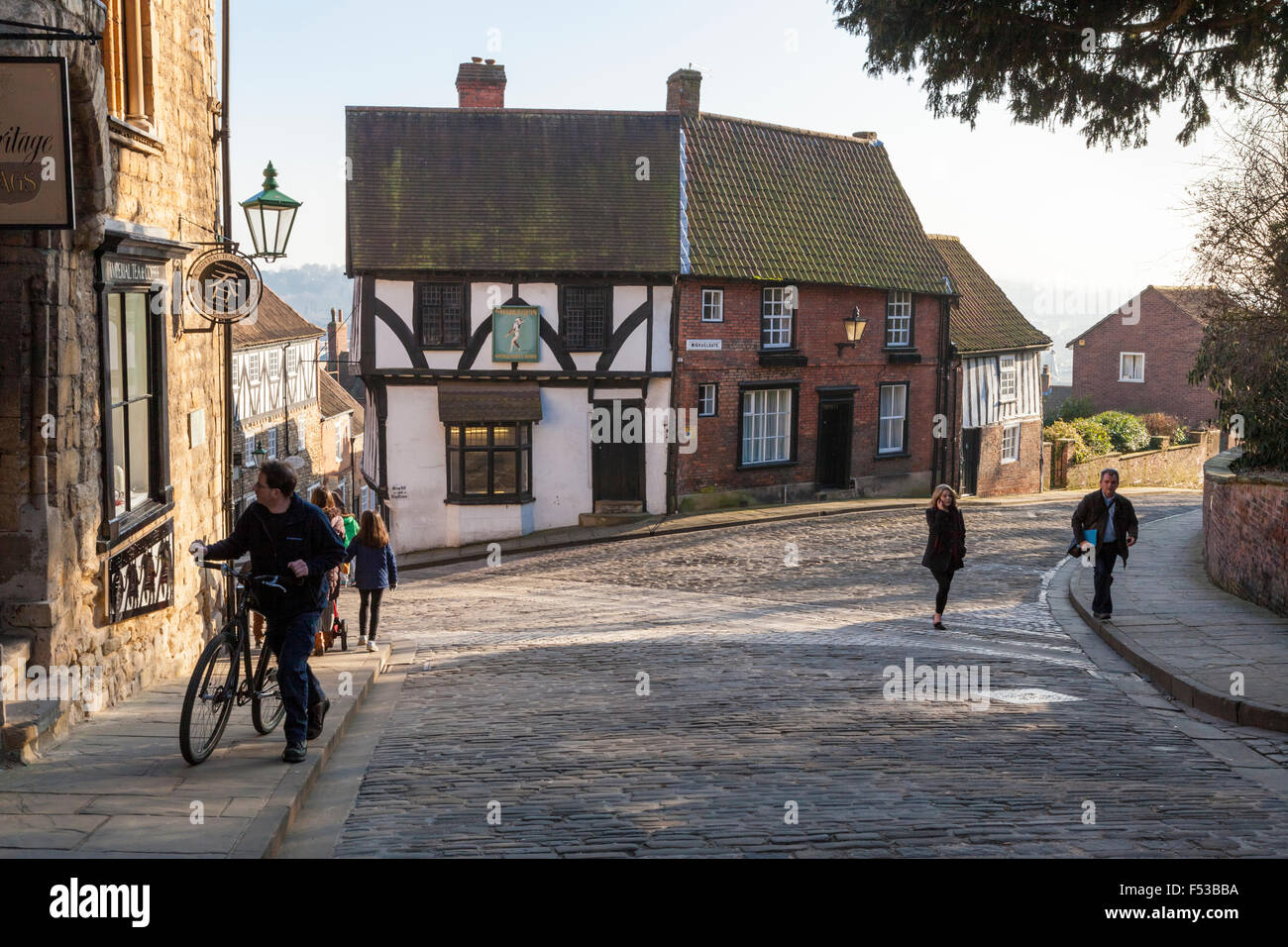 Old buildings and cobbled streets where Steep Hill and Michaelgate meet in Lincoln, England, UK Stock Photo