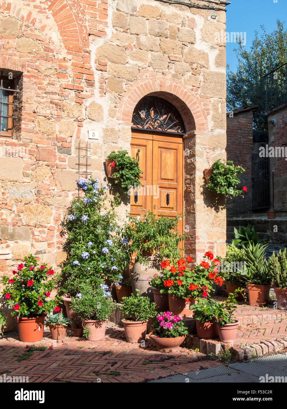 Europe, Italy, Tuscany, Monticchiello.  Flower displays near house in the medieval town of Monticchiello. Stock Photo