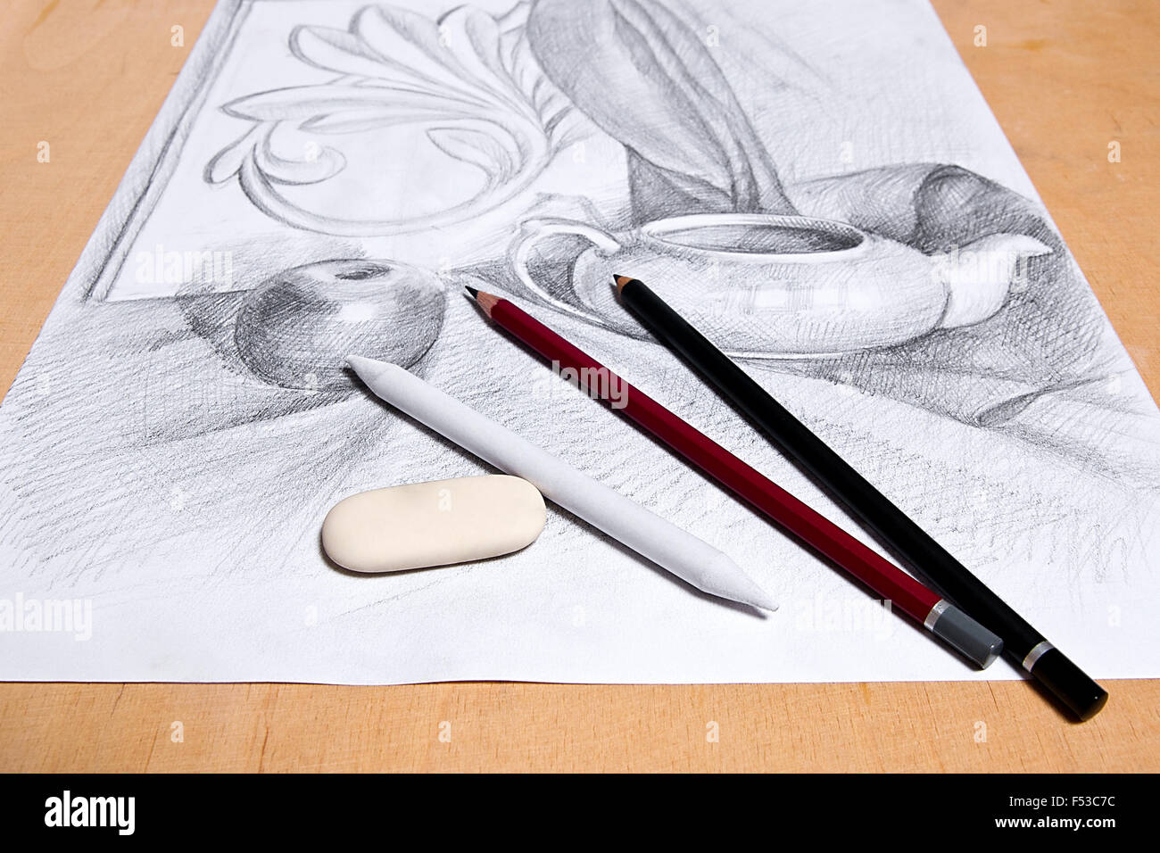 Drawing of still life by graphite pencil with apple, tea infuser and plaster palm leaf. Graphite pencils and eraser on the woode Stock Photo