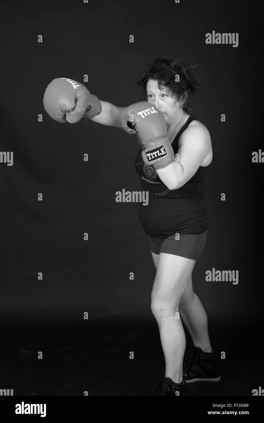 Thirty's woman boxer posing in the photo studio, September 2015 Stock Photo