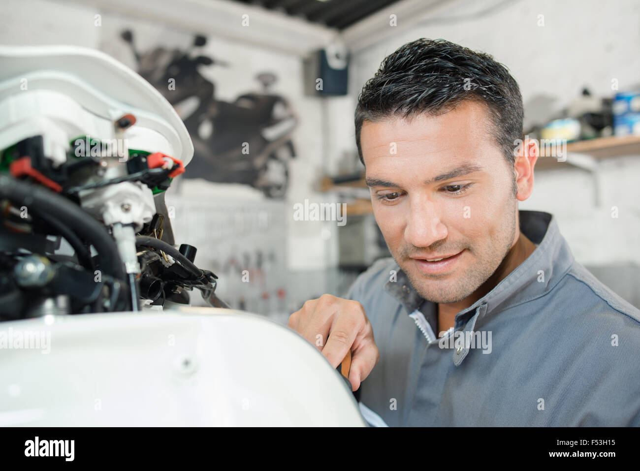 Mechanic working on a scooter Stock Photo