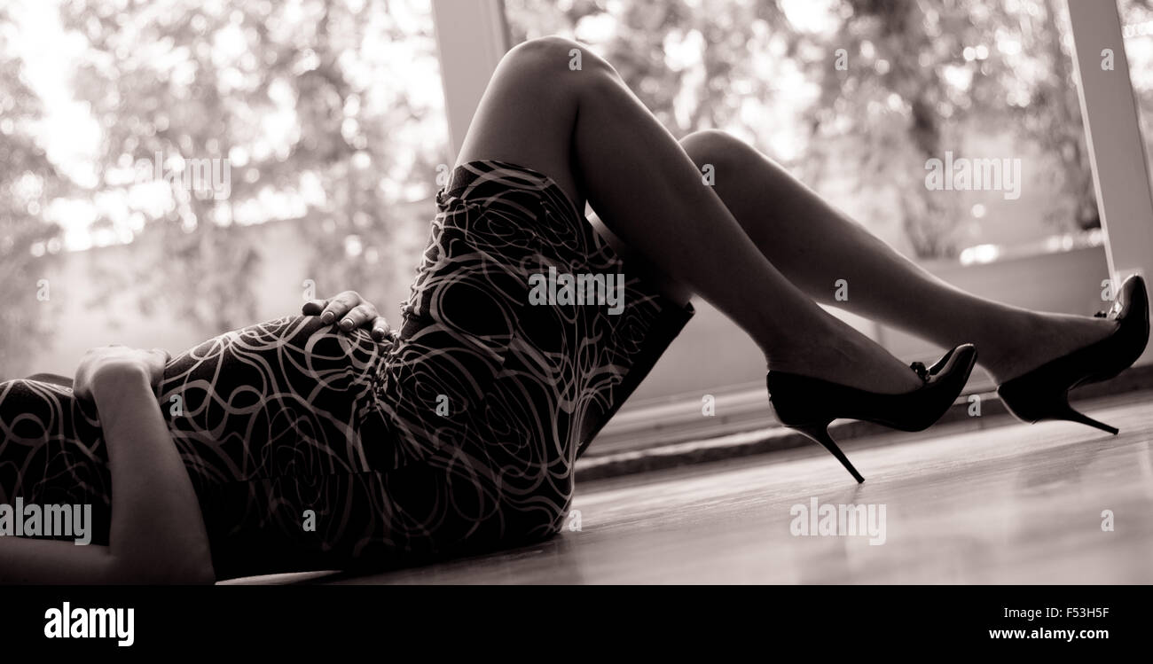 Pregnant woman in hi heels lying on the floor Stock Photo Alamy