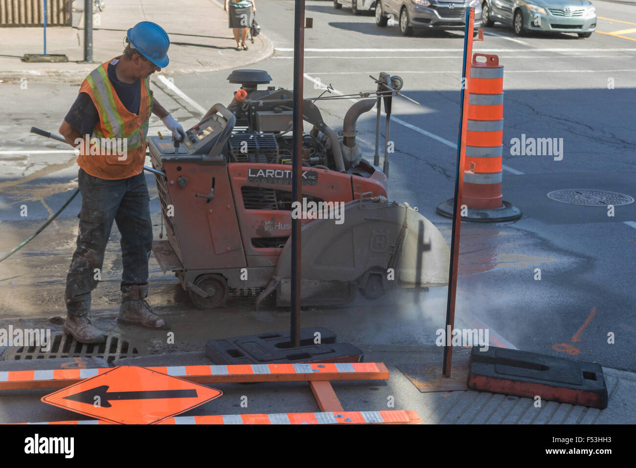 An Asphalt Zipper pulverizing asphalt and injecting water through a spray bar to repair a surface