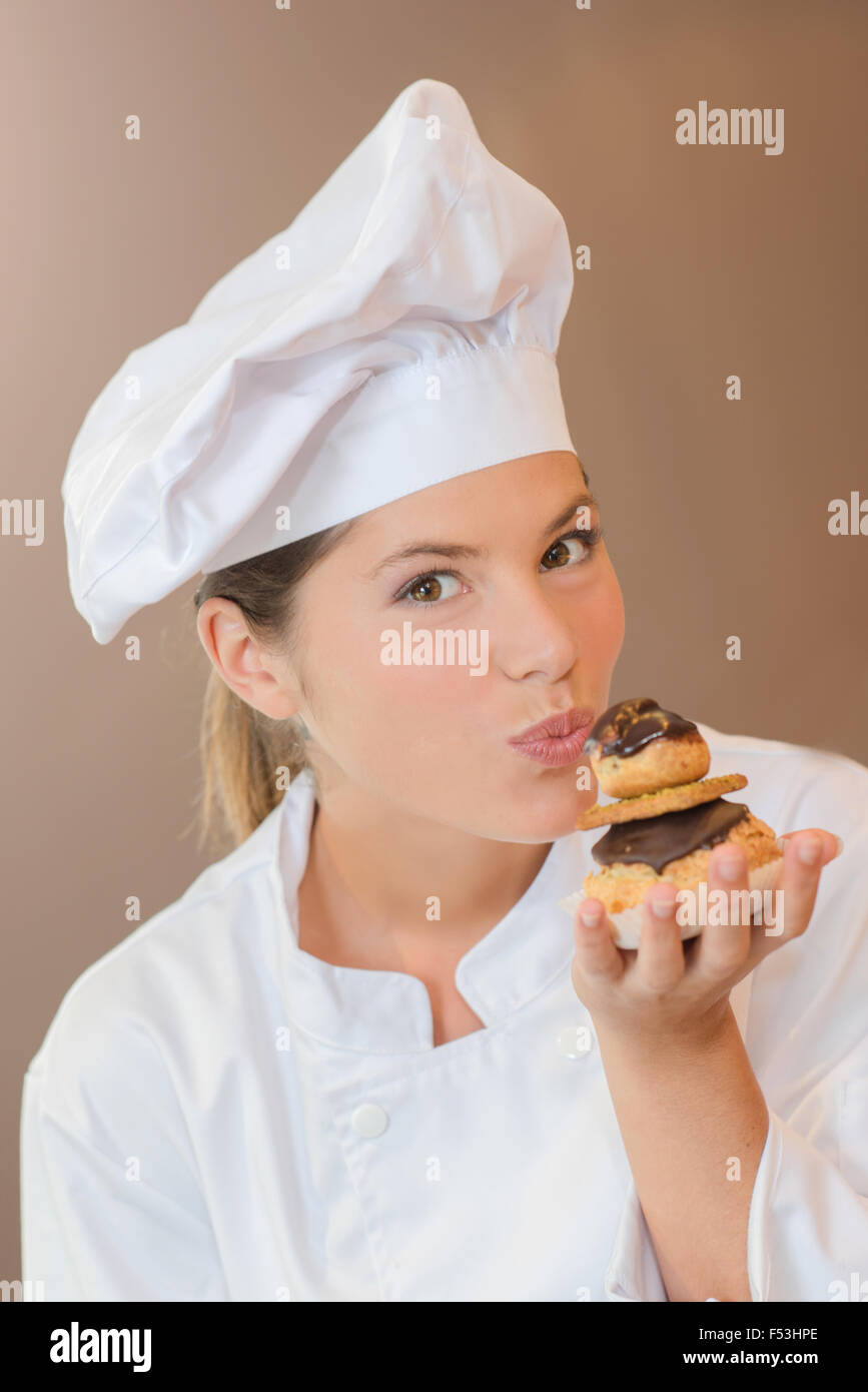 Chef kissing a profiterole Stock Photo