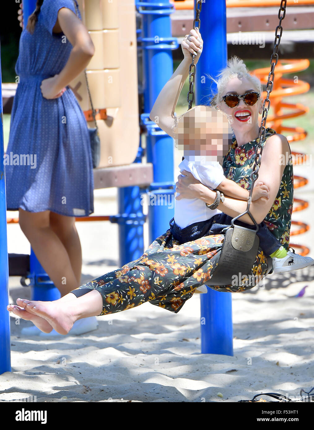 Gwen Stefani, with her wedding wing removed, goes barefoot as she plays in  the park with Apollo on a swing Featuring: Gwen Stefani Where: Los Angeles,  California, United States When: 23 Aug