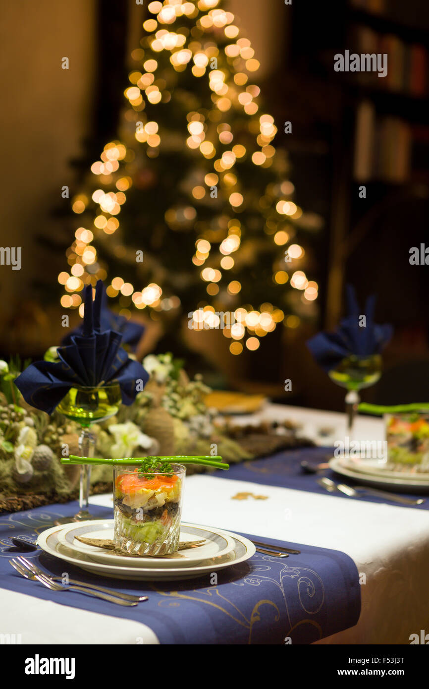 Decorated Christmas dinner table with seafood verrine als a starter Stock Photo