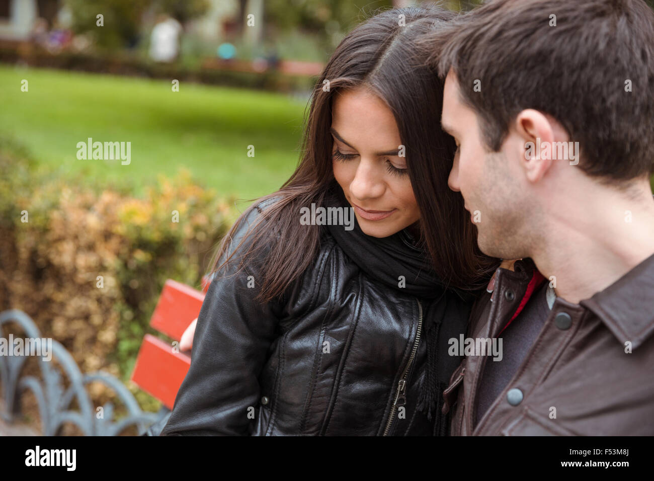 Portrait of romantic couple sitting on the bench outdoors Stock Photo ...
