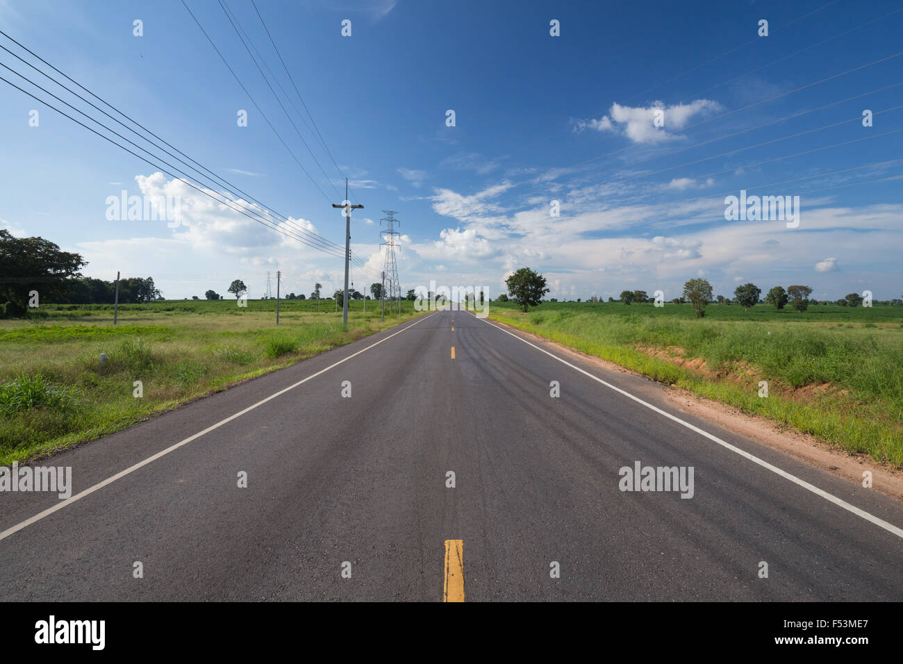 asphalt road through the green field with blue sky Stock Photo - Alamy
