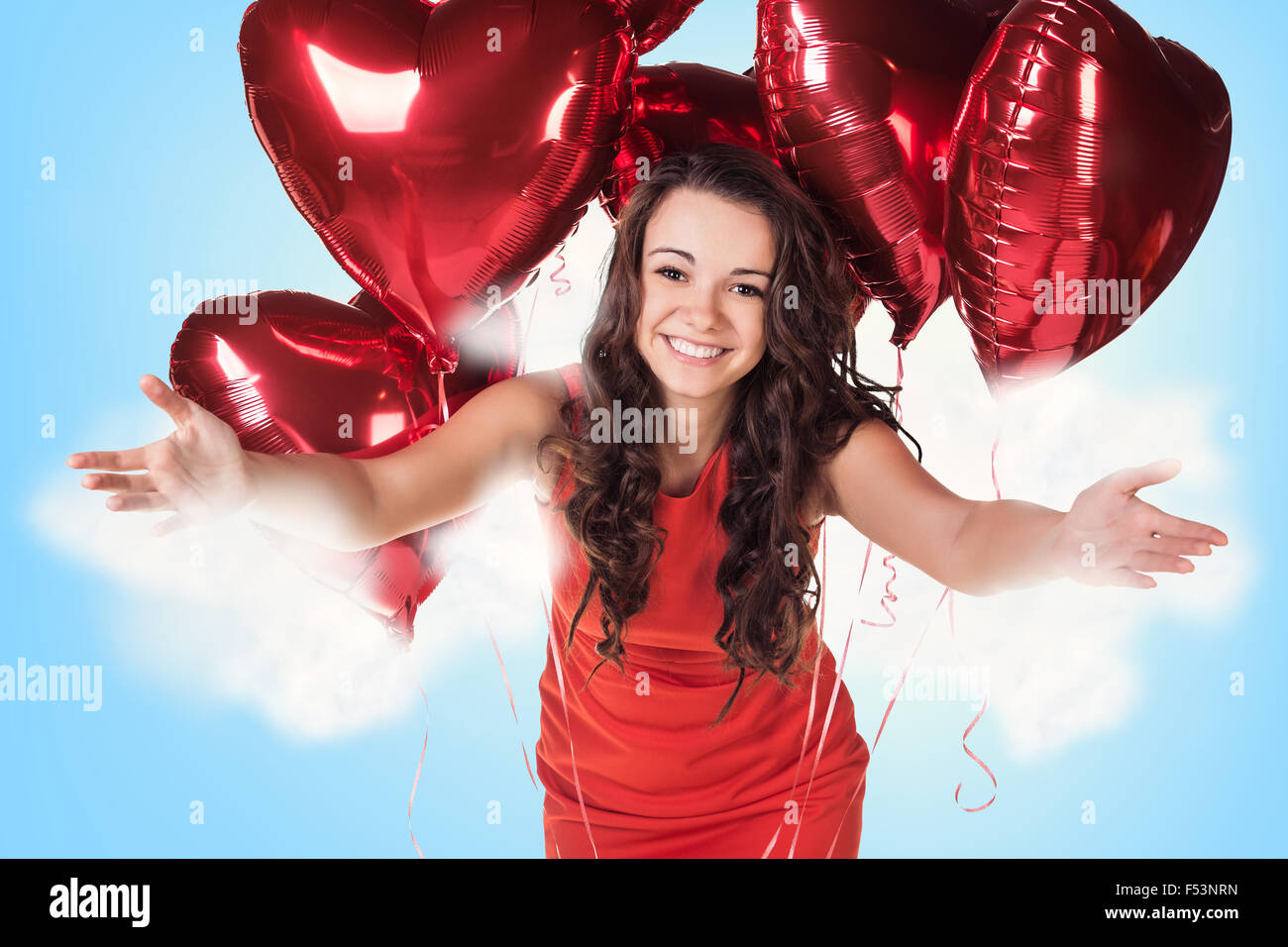 Young woman in red dress with balloons Stock Photo