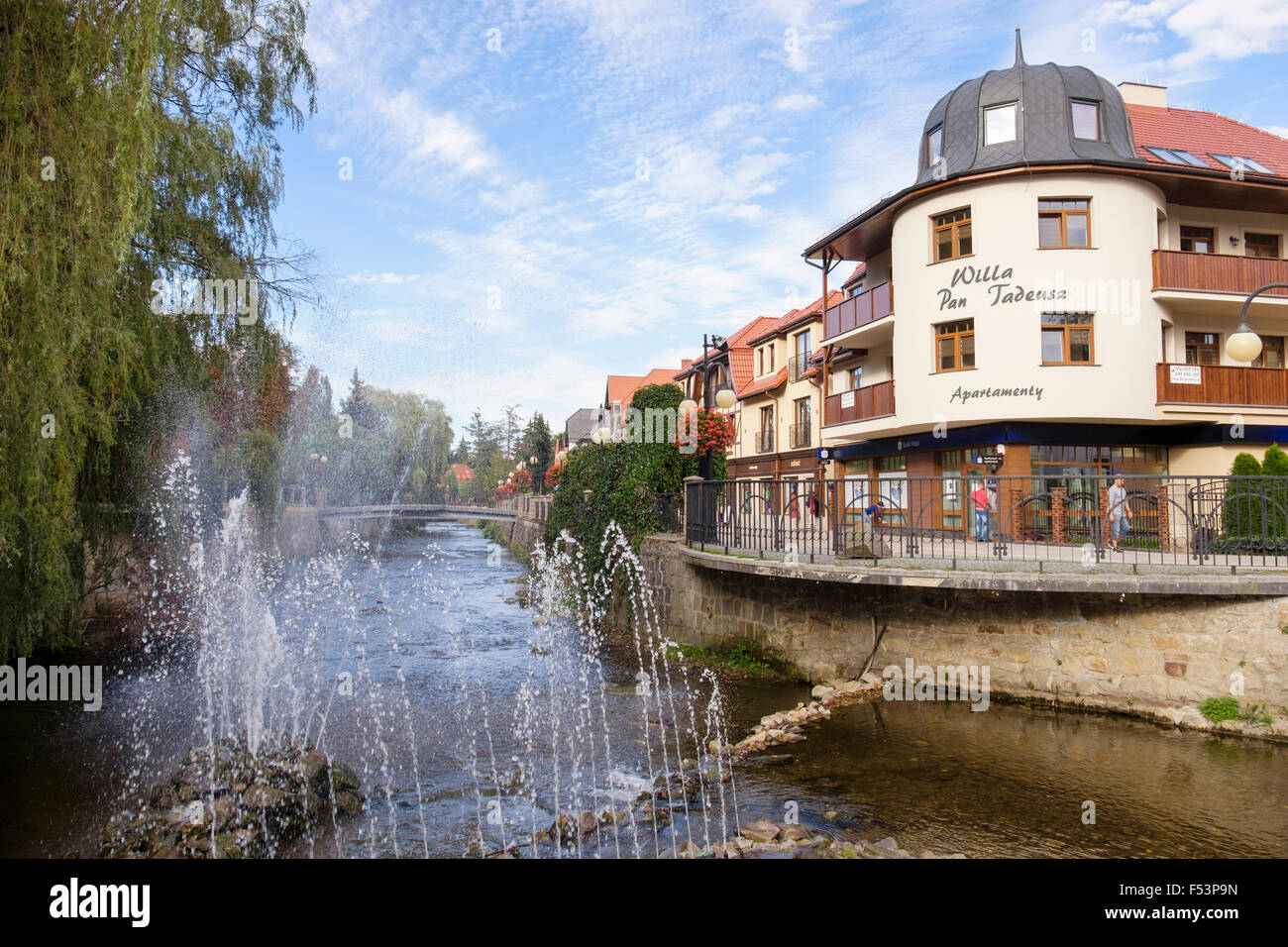 Water feature on Bystrzyca Dusznicka river with shops in centre of piedmont spa town. Polanica-Zdroj, Lower Silesia, Poland Stock Photo
