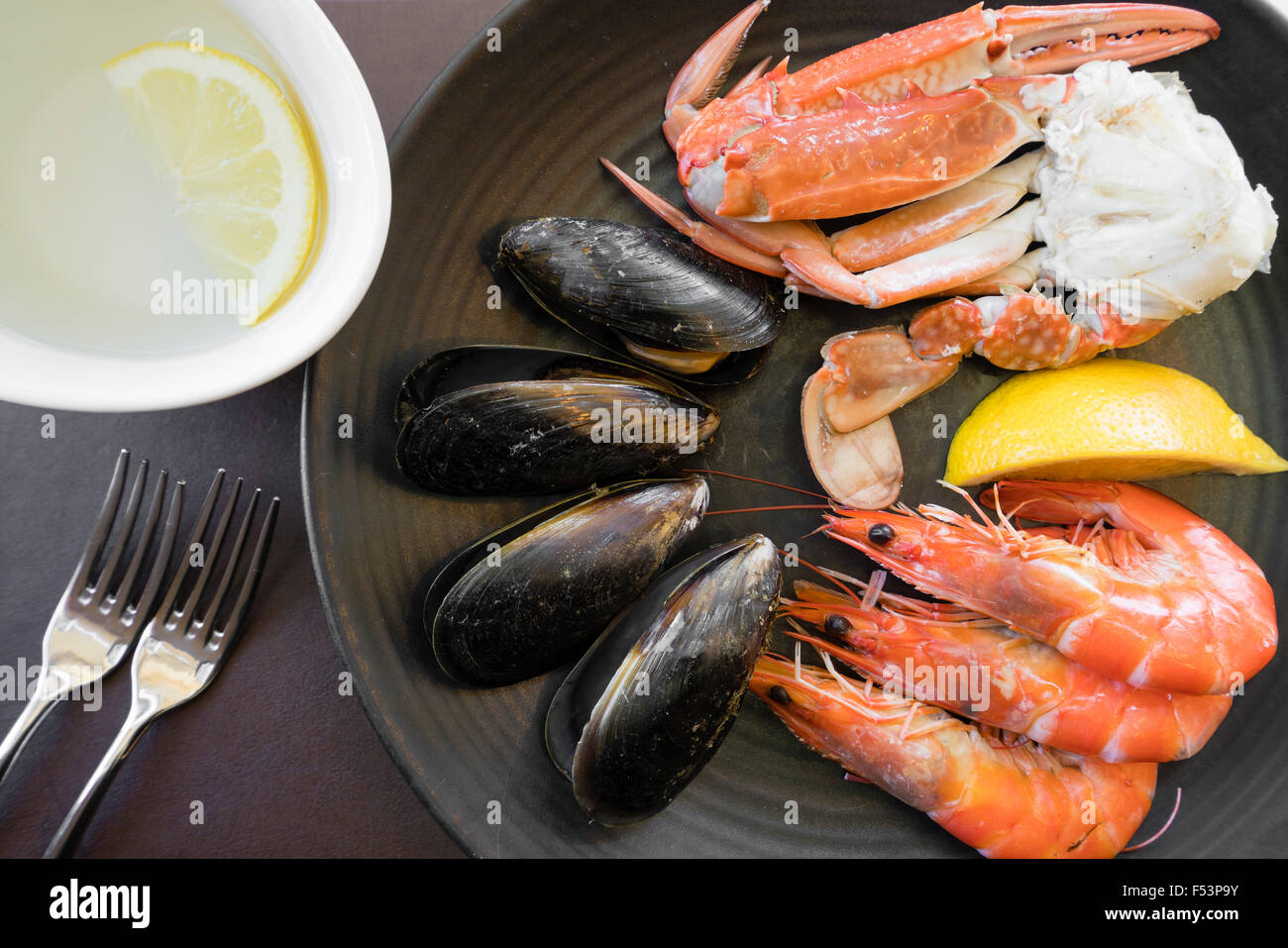 Top down view of seafood on plate and finger bowl Stock Photo
