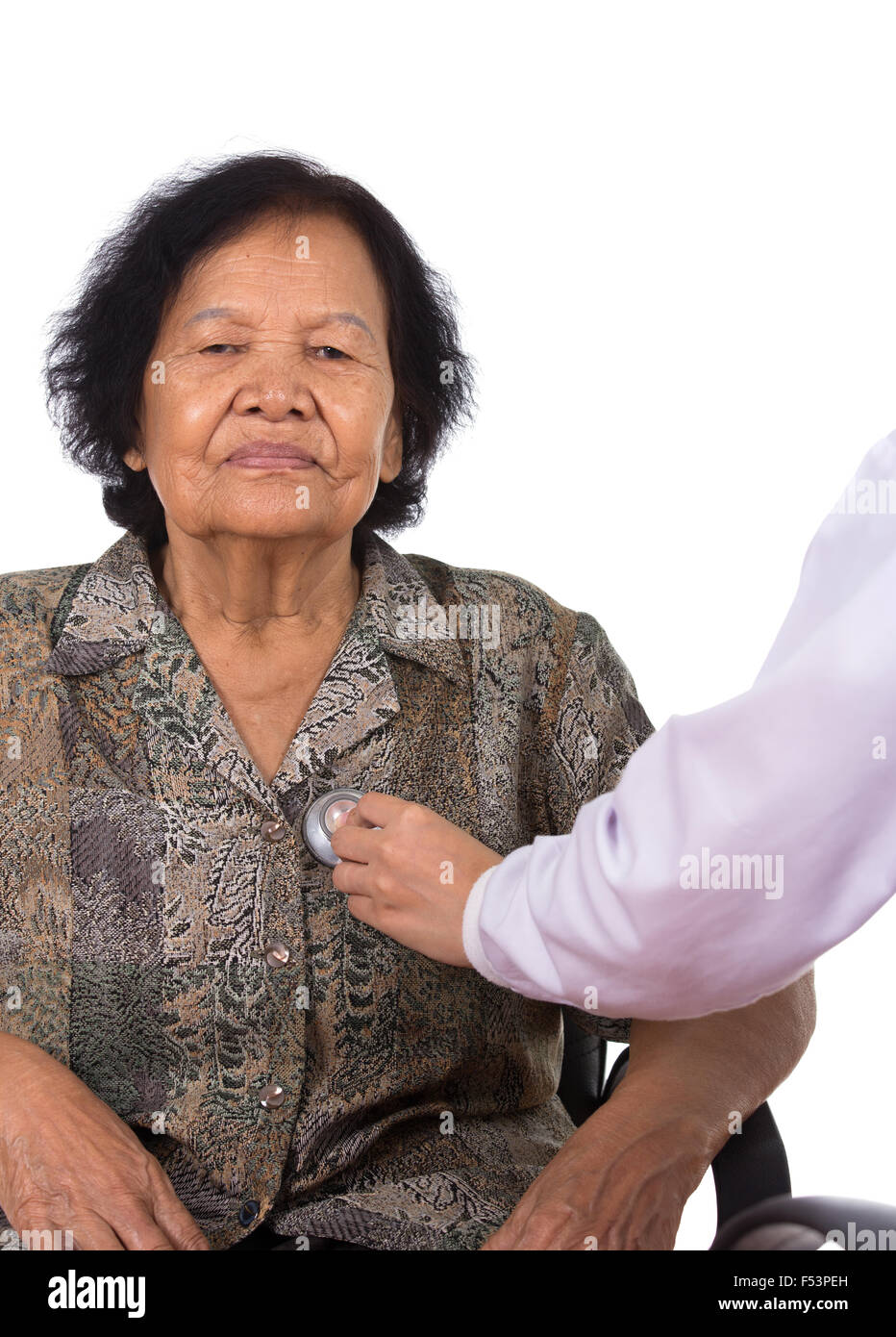 doctor listening to elderly patient's heart isolated on white background Stock Photo