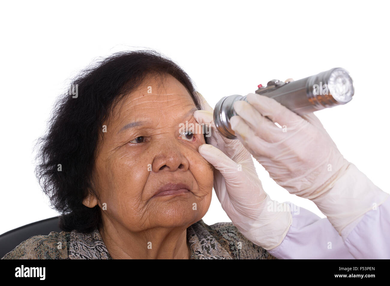 Neurologist testing reflexes of the eye of young woman on white background Stock Photo