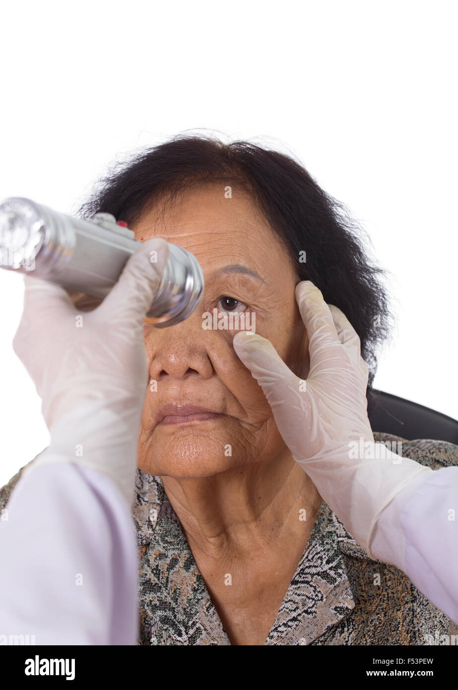 Neurologist testing reflexes of the eye of young woman on white background Stock Photo